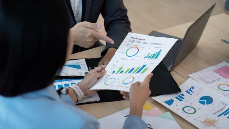 Business team analyzing financial report in modern office, strategy concept